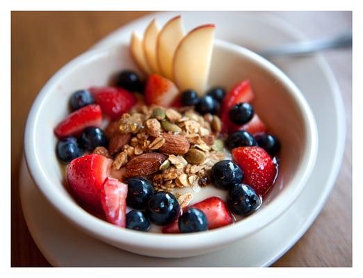 Yogurt, fresh fruit and granola with honey and mint