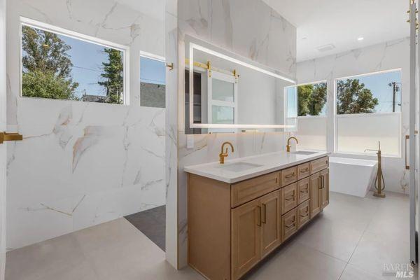 Amazing master bathroom , tiled walls with a modern concept shower, heated floors, with custom quartz countertops