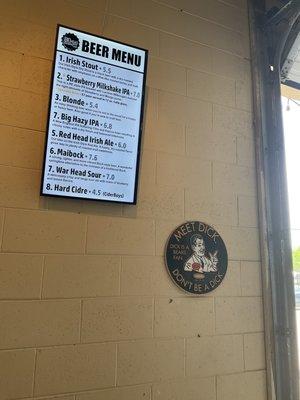 Beer menu and sign inside taproom.