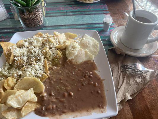 Chilaquiles verdes w/ papas fritas, frijoles, y dos huevos estrellados . Can't forget the so delicious coffee .