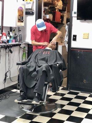 Old fashioned shave, after the hot towel was removed from his face.