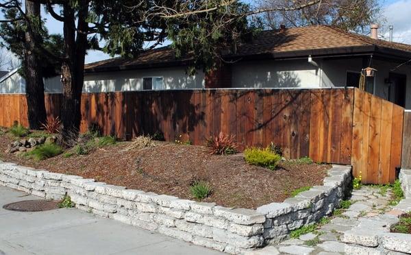 We repurposed concrete rip-rap and created a retaining wall, we also reused redwood fence boards on this project.