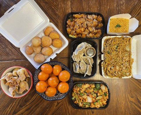 Crab rangoons, donuts, steamed dumplings, garlic chicken, sesame chicken, chicken lo mein, and fried rice