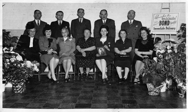 Morton Cleaners war bond drive, early 1940s
 Owner Rose Schlossberg holds photo of Son Martin who was serving, Husband Isadore behind her