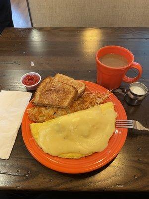 Pops omelette- sausage, ham, bacon, peppers, onions topped with hollandaise sauce. Shredded hash browns and wheat toast. Delicious.