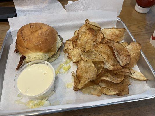 Pepper Jack Cheeseburger with pickles, mustard, bacon, as well as chips and queso.