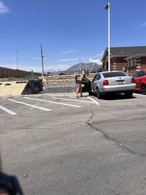 Couple has a car cleaning business taking the few and necessary open parking spots.