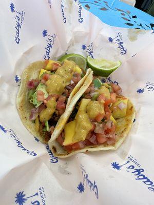 Chorizo tacos with mango salsa, avocado and hot sauce