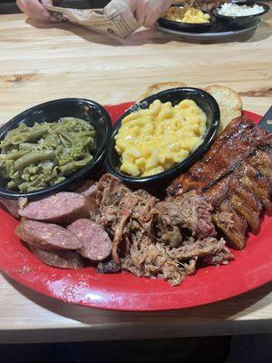 Pick 3 Combo with jalapeño sausage, pulled pork and baby back ribs. Sides are green beans and Mac cheese.