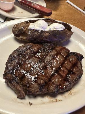 A ribeye and a baked potato