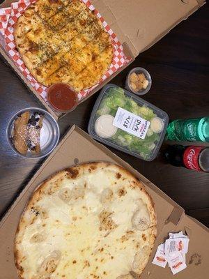 Blonde bombshell pizza, cheesy bread, and Caesar salad.