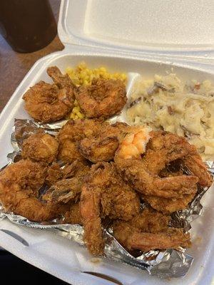 Fried shrimp dinner with corn, mashed potatoes, and hush puppies