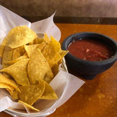 Warm chips and nicely spice salsa.