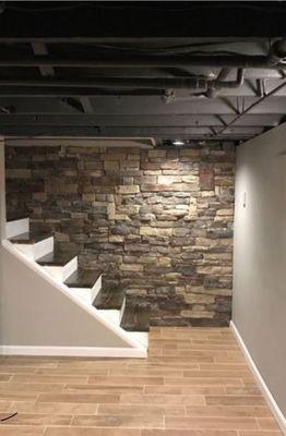 Finished basement with accent wall