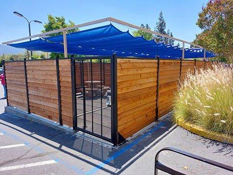 Horizontal slide-wire pull canopy system (Roman Shade) in free-standing steel structure.