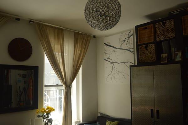 We mounted the curtains and mirror, installed the light fixture, and assembled the furniture.