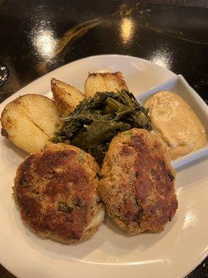 Crabcake dinner with red potatoes and collard greens