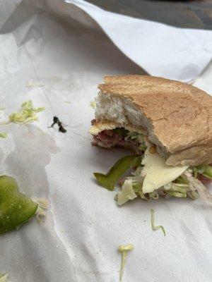 Yelp is asking me "what is in this photo?" I have the same question. Wad of shower drain hair in my Italian sub.