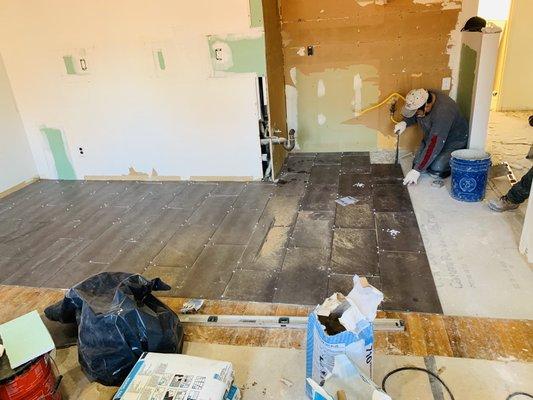 Installing new floor tile on kitchen by United