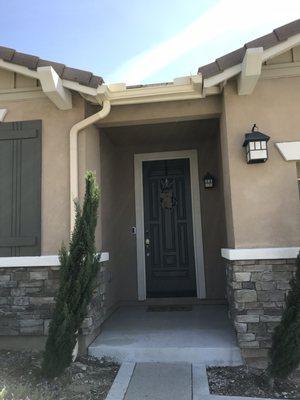 Rain gutter installed over the front entry landing. Rain poured down like a waterfall. Problem solved!