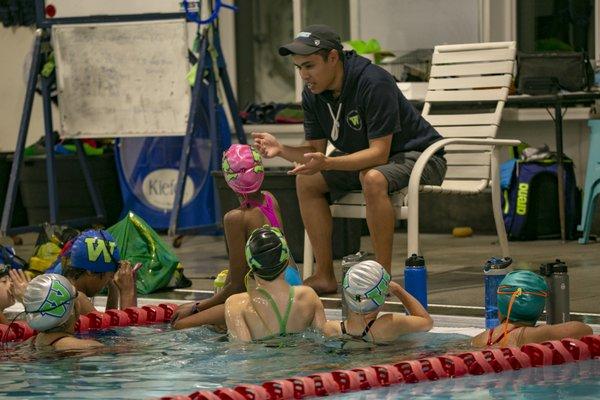 Coach working with swimmers