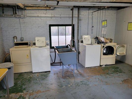 Very old laundry room in very poor condition