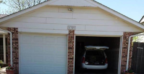 The original 1978 Masonite siding with horizontal gable vents at the peak.