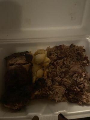 Small Jerk chicken meal with Mac and cheese and rice and peas (sorry it's so dark)