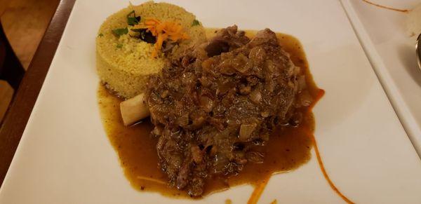 Méchoui: Roasted lamb shank served with couscous