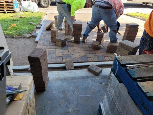 Guys working on laying the pavers.