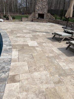 Travertine patio / deck around pool.