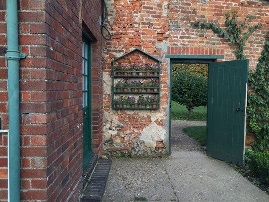 A sweet wall hanging of small pots