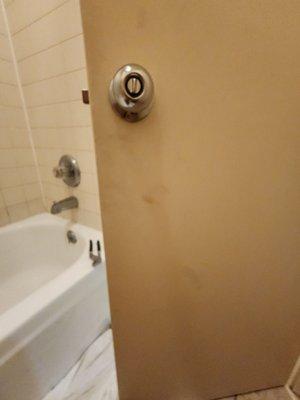 The dirt on the back of the bathroom door