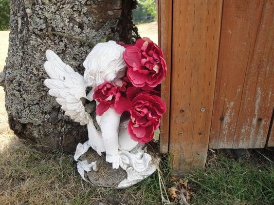 crumbled remains of a cherub by the trash