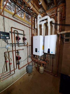 Installation of Navien Tankless Water Heater and Navien Combi-Boiler Units.