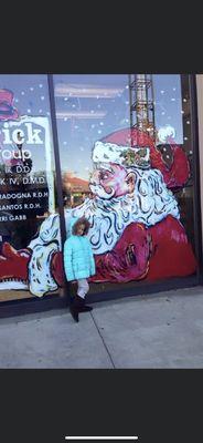 Front window of Frederick Dental Services during the Winter holiday. Window are painted by local artist