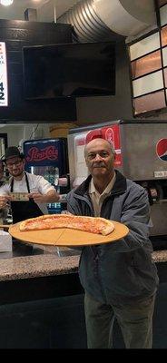 First customer enjoying his pizza.