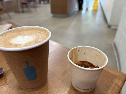 Cappuccino and espresso. Notice the difference in presentation. Also bummed they only use paper cups now.