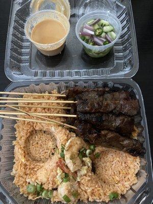 S8 beef sate dinner. Shrimp fried rice, beef skewers, dipping sauce, and garnish.