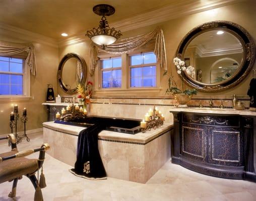 This trac bath has been transformed with custom cabinetry, honey onyx and jet mosaic splash with cross cut travertine, & Venetian plaster