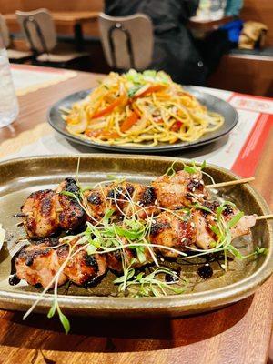 Chicken skewer, panfried noodle in back