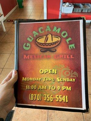 Front of menu with hours and phone number for take-out