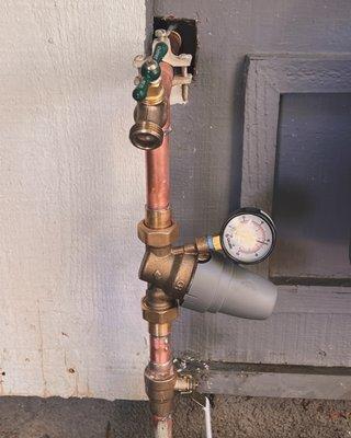 Residential water main.  New install of main water valve, a Caleffi pressure reducer, and hose faucet.