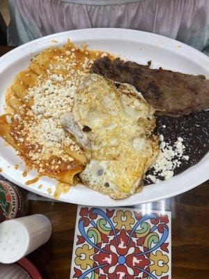 Thin piece of cheap beef. Fried egg. Some spicy enchiladas. Bad beans. Cheese was probably okay.