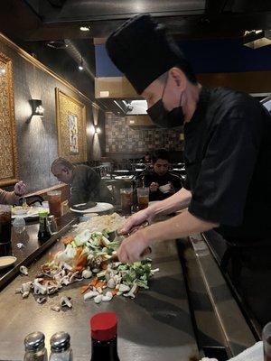 Chef grilling on the hibachi.