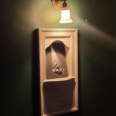 Old fashioned phone alcove repurposed for art