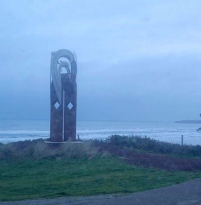 Sculpture at dusk and if you squint you can see the lighthouse on the far right.