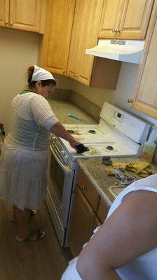 Juanita working on the stove