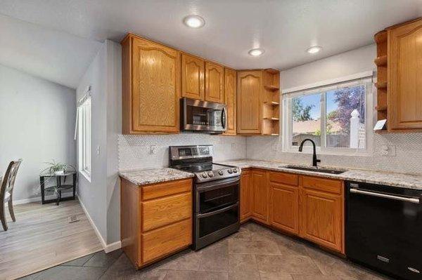 We upgraded this kitchen with new appliances, granite counters, ceramic tile and paint.