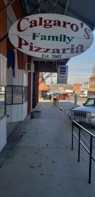 Outside of restaurant, hanging sign